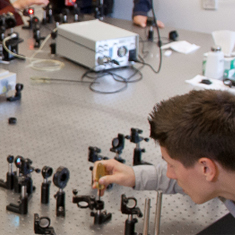 student examing machinery